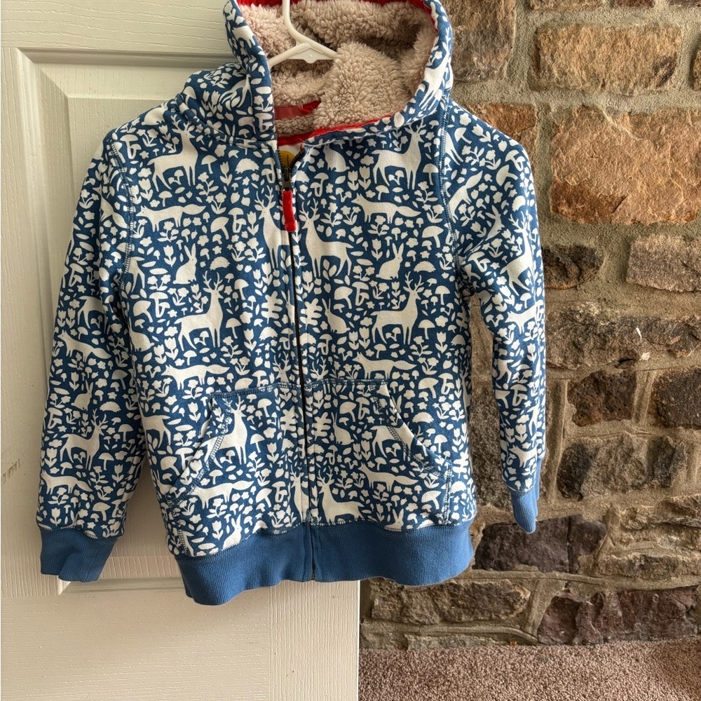 Blue hoodie with nature patterns, furry inside size 9 to 10-year-olds, zip up.